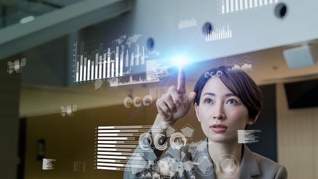 Woman touching a floating digital interface with charts
